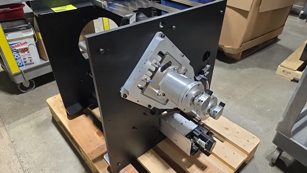Custom-built laboratory automated equipment assembly. Features black plate chassis, (2) Kollmorgen motors (P/N: KBM-25H02-A00), multi-station pneumati