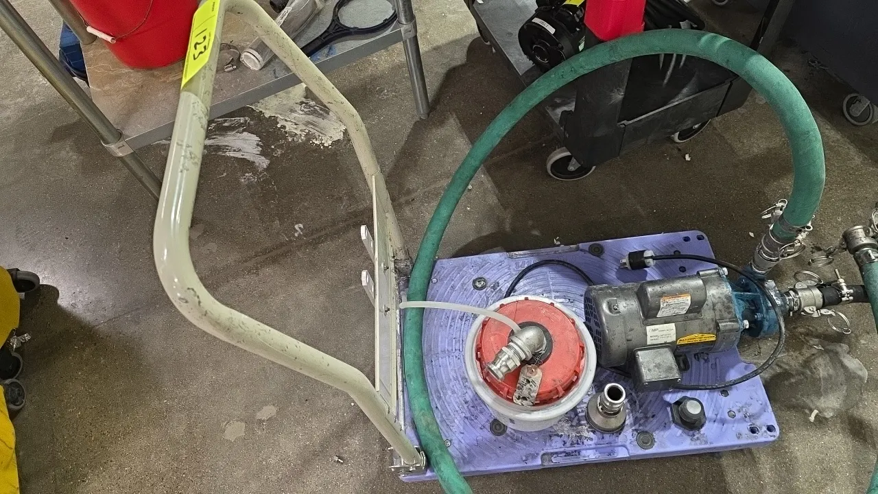 MP Pumps MP24189 portable motor pump unit. Powered by a Baldor-Reliance 0.5 HP industrial motor. Features fluid mixing container, green hose, and quic