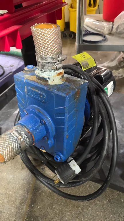 AMT 2761-95 self-priming centrifugal pump. Features a 2 HP commercial-duty motor, cast pump housing, attached inlet and outlet hose segments with hose