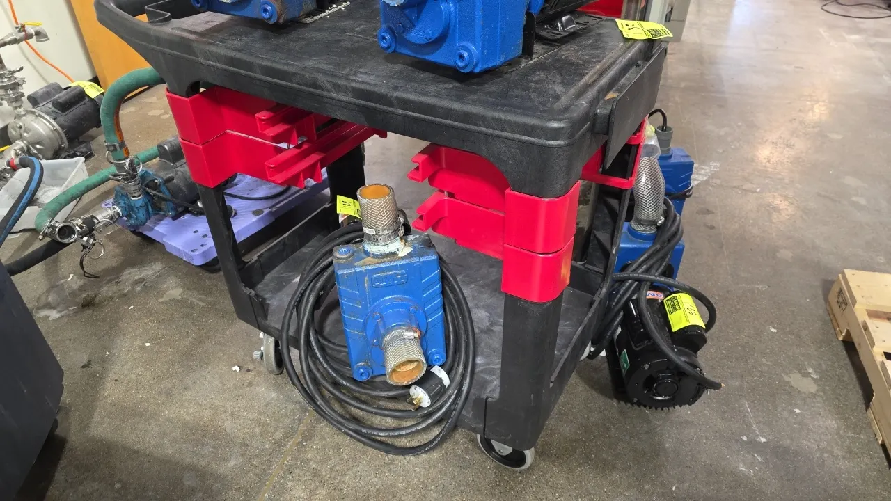 Polymer 2-tier utility cart. Features molded plastic construction, integrated push handle, and side accessory rails. Mounted on swivel casters. Conten