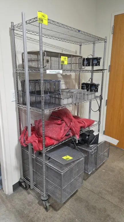 Chrome 5-tier wire shelving unit. Features five wire shelves and side-mounted dual-fan cooling assemblies with power cord. 48" x 18" x 77". Mounted on