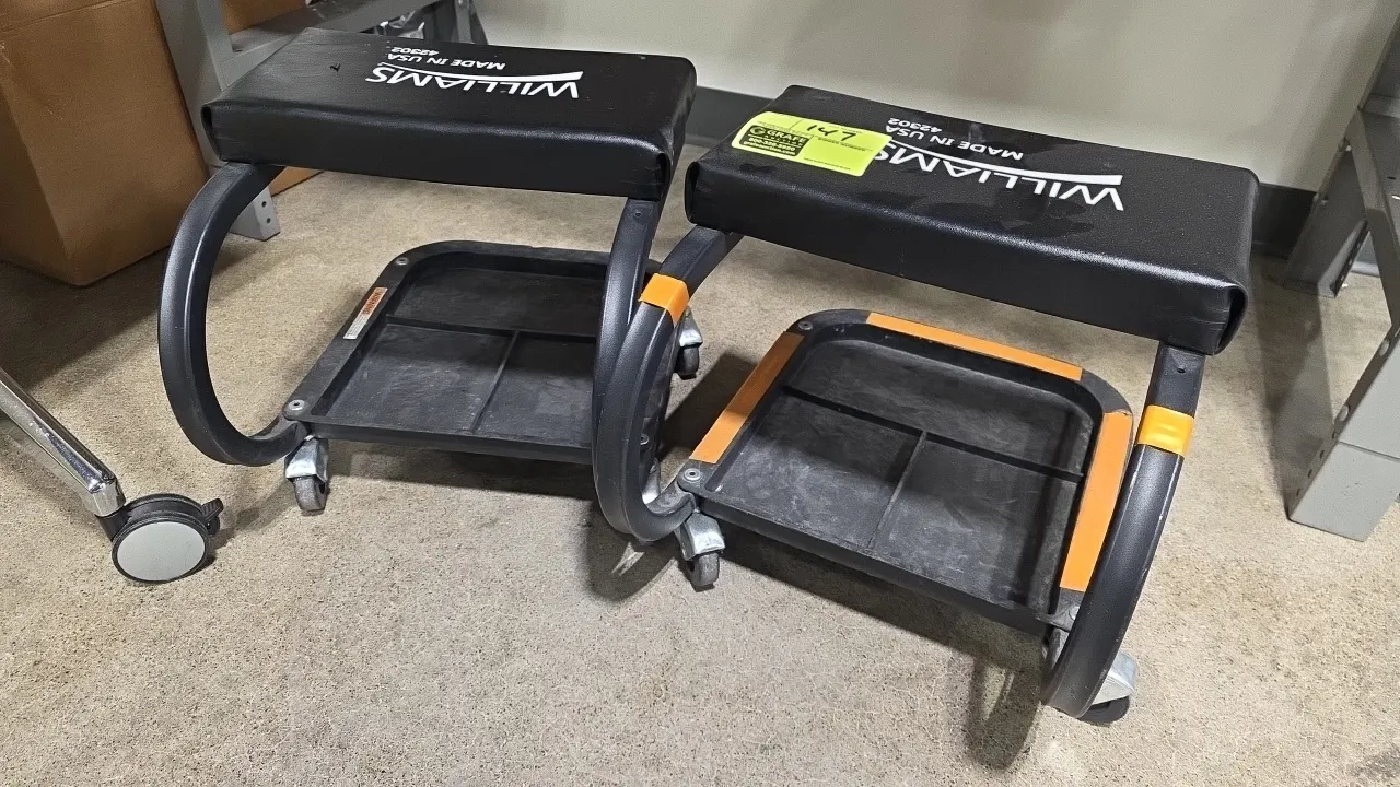 Williams 42302 rolling mechanic creeper seats. Features padded vinyl seats, lower segmented tool trays, and tubular steel frames. Mounted on swivel ca