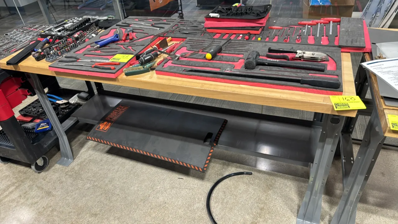 Metal workbench. Features a wood top and lower metal shelf. 72" x 30". Contents not included.