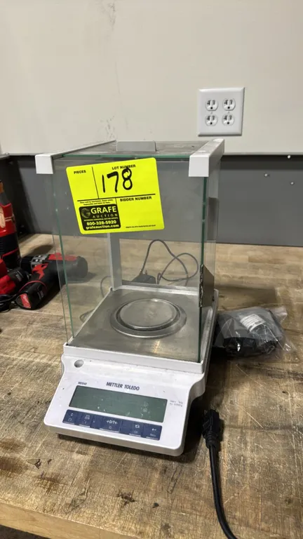 Mettler Toledo ME54E electronic analytical laboratory scale. Features 52g maximum capacity, 0.1mg readability, glass draft shield with sliding panels,