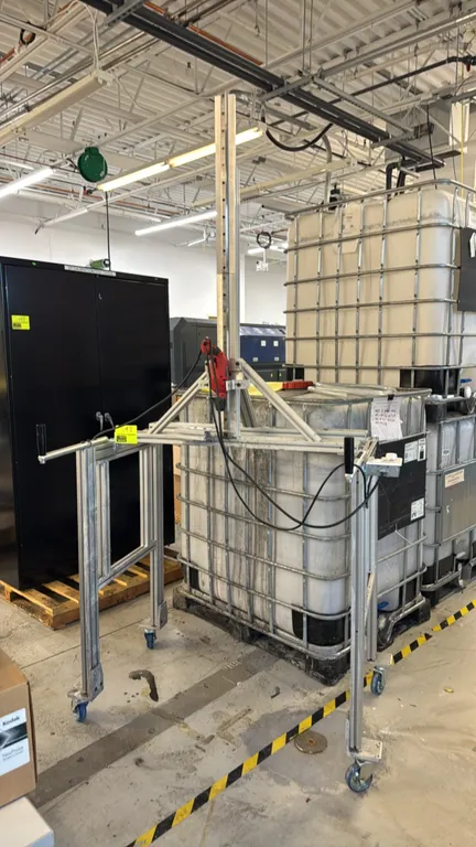 Custom portable drill station. Features extruded aluminum frame construction, mounted corded drill on a vertical linear guide rail, integrated electri