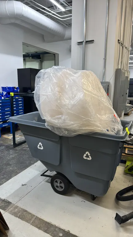Poly tilt trash cart. Features molded polyethylene construction with recycling graphics and 1 cu. yd. capacity. Mounted on a tubular steel frame with