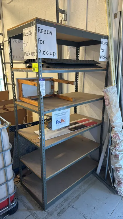 Metal 6-tier shelving rack with wood decks and contents. Features boltless steel frame construction and 6 composite wood deck levels. Includes content