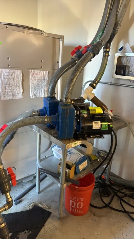 AMT 2761-95 electric pumps. Includes attached reinforced hoses and a 3' x 2' Regency stainless steel table with undershelf. Features 2 HP commercial d
