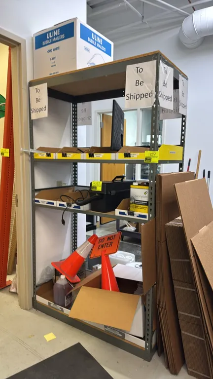 4-tier metal storage rack. Features steel rivet frame construction with wood decking. 4'L x 2'W x 7'H. Contents not included.