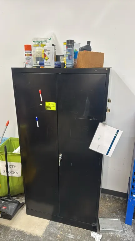 Tennsco 2-door metal storage cabinet. Features dual hinged doors, handle latch, and interior shelving. 3' x 2' x 6'. Includes assorted contents compri