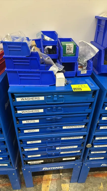 Fastenal 8-drawer metal hardware cabinet. Features slide-out compartmentalized metal storage cases. Includes assorted top plastic bins filled with var