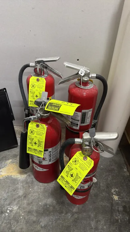 Amerex fire extinguishers. Assortment includes a carbon dioxide (CO2) extinguisher with discharge horn and dry chemical extinguishers including model
