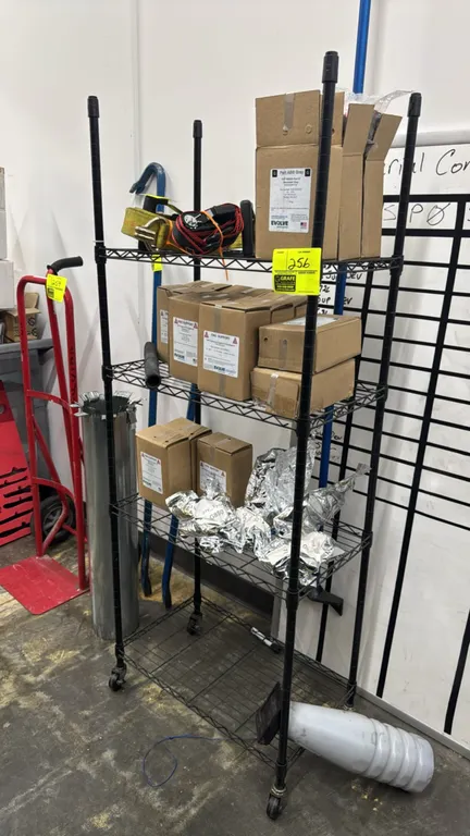 Metal 4-tier portable wire rack. Features black finish and adjustable wire shelves. 24"L x 14"W x 62"H. Mounted on casters. Contents not included.