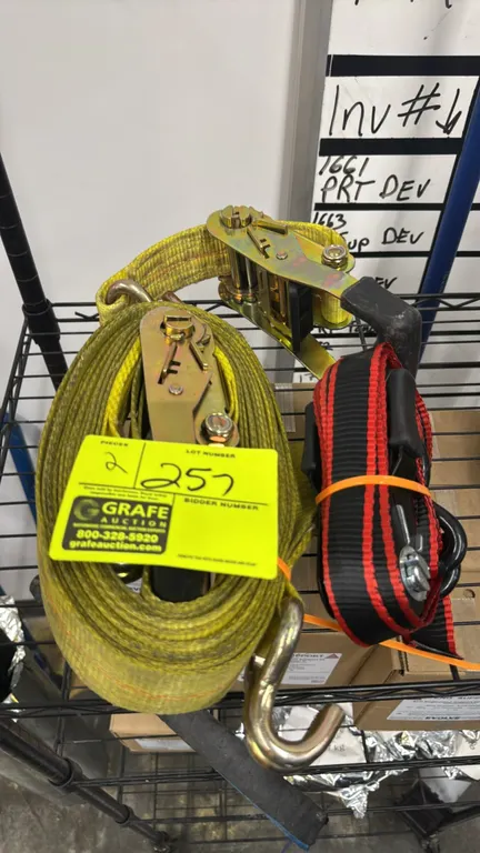 Ratchet straps. Includes (1) 2"W yellow strap with double J-hooks and (1) 1 1/4"W black and red strap with coated hooks. Each features a manual ratche