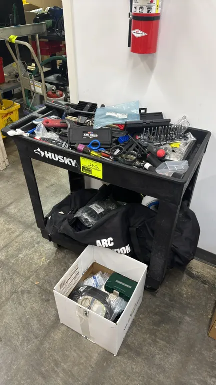 Husky 2-tier polymer utility cart. Includes assorted hand tools, hex key set, sockets, screwdrivers, extension cords, duffel bag with PPE gear, and mi