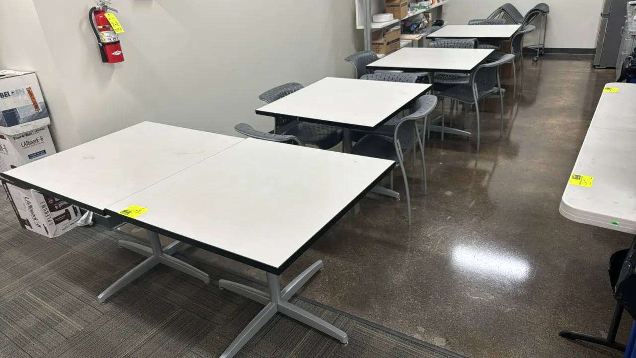 Laminate tables with metal bases and poly molded chairs. Tables feature laminate tops with protective edges on silver-tone metal bases, measuring 3' x