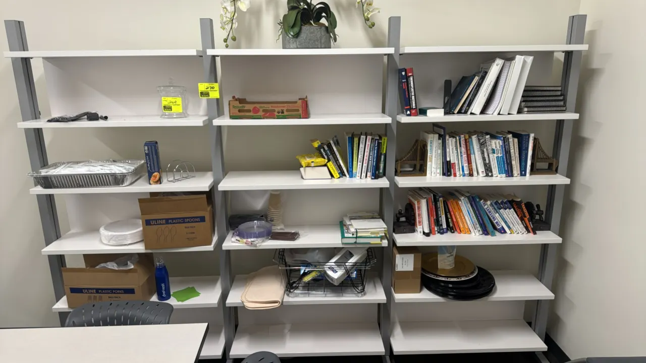 Metal and laminate 6-tier shelving unit. Features a 3-bay design with silver-tone metal uprights and white laminate shelves. Dimensions: 116"W x 18"D