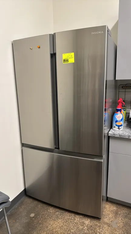 Insignia NS-RFD26SS9 French door household refrigerator with bottom freezer drawer. Features stainless steel exterior, digital temperature controls, a