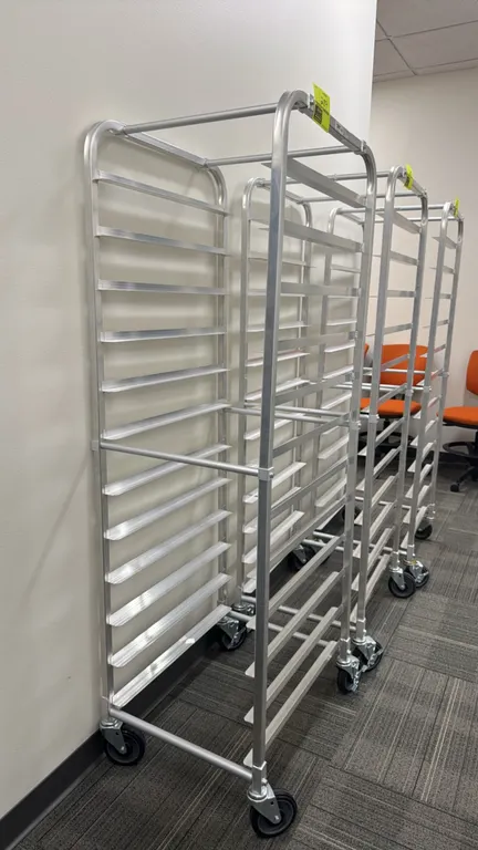 Full-size aluminum front-load sheet pan speed rack. Features 20 pan slides. Mounted on swivel casters.