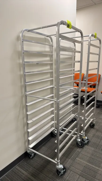 Full-size aluminum front-load speed rack. Features 20-tier sheet pan runner slides. Mounted on swivel casters.