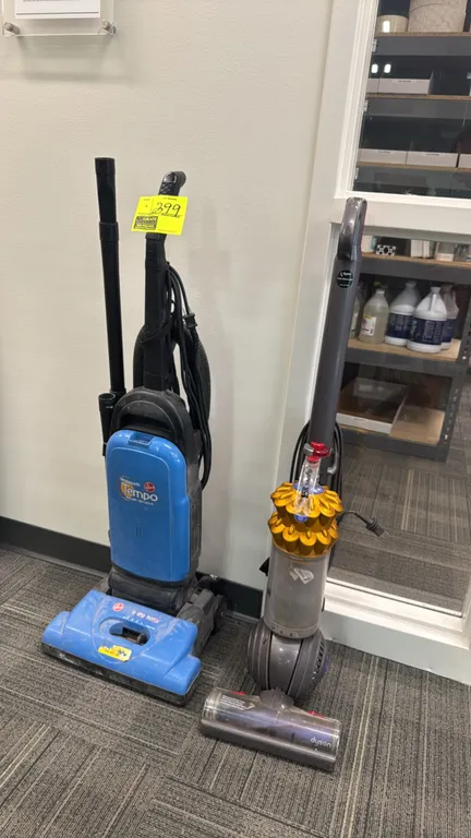 Vacuum cleaner lot. Includes (1) Dyson DC50 upright vacuum cleaner with Ball technology and bagless canister, and (1) Hoover Widepath Tempo upright va