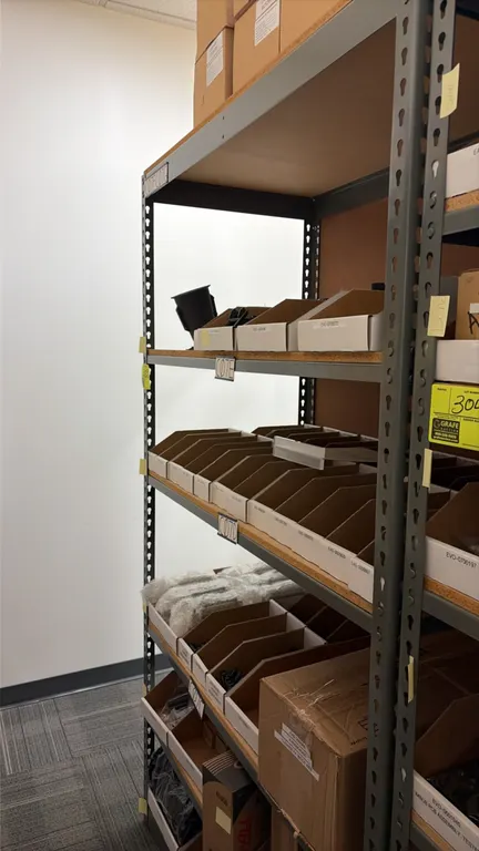 Light-duty metal shelving unit. Features steel upright frame, particle board decking, and multiple shelf tiers. 48"W x 24"D x 84"H. Includes cardboard