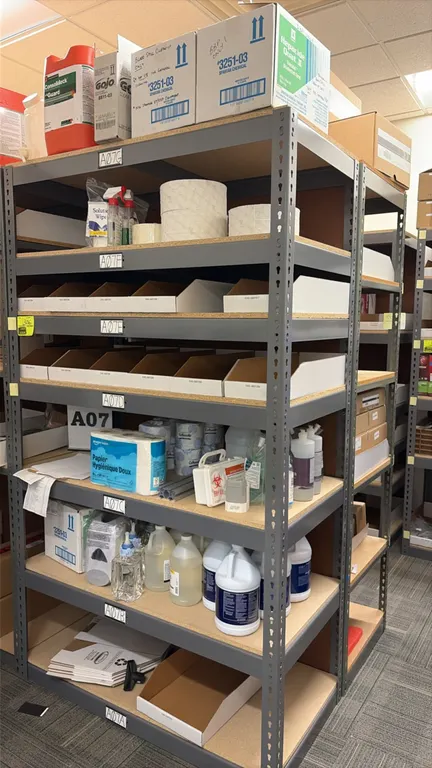 Light-duty steel shelving unit. Features 7 shelf levels with particle board decking and gray finish. Includes assorted cleaning supplies, paper towels