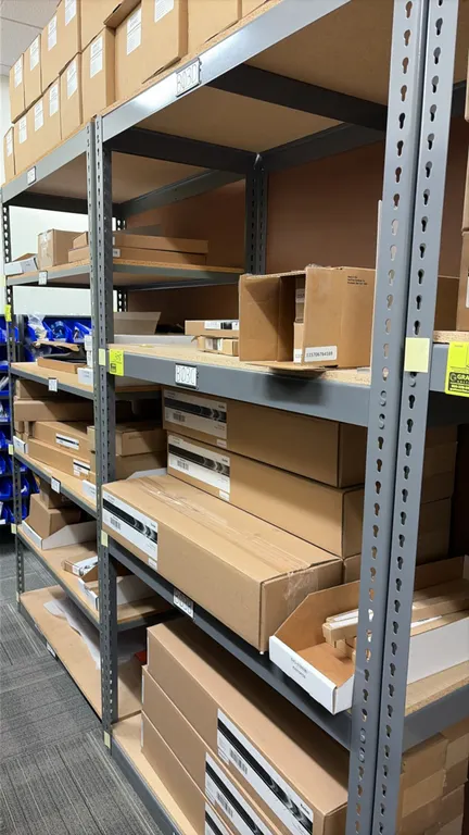 Light-duty storage racking with assorted Kodak NexPress supplies. Includes blanket cylinder cleaners, primary and IC preclean wires, conditioning char