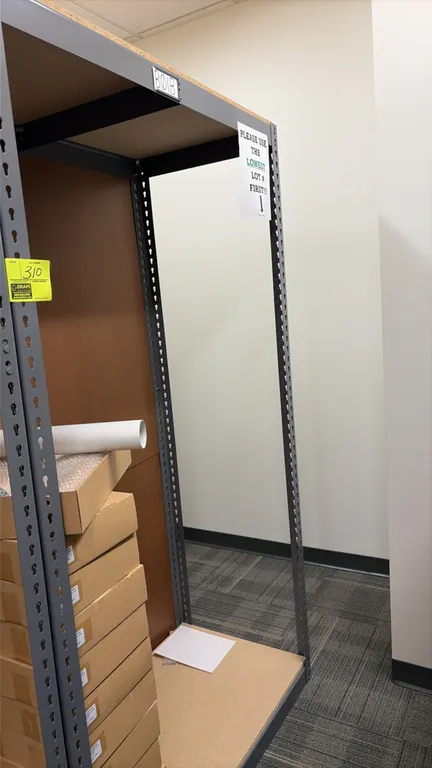 Light-duty boltless shelving rack. Features steel frame and particle board decking. 48" x 24" x 84". Includes stacked cardboard boxes and shipping cyl
