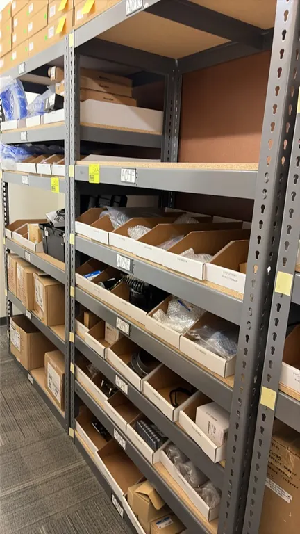 Light-duty industrial racking unit. Features gray steel frame with boltless rivet assembly and particle board decking. 48" x 24" x 84". Contents not i