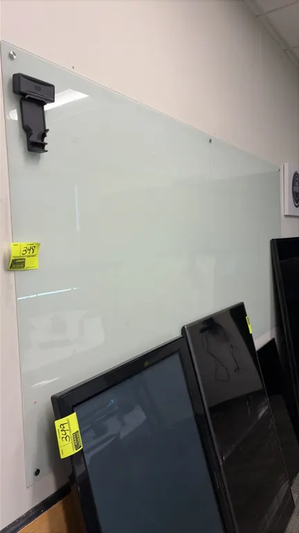 Frameless glass dry erase board. Features opaque white glass writing surface and standoff wall mounting hardware. 8' x 4'. Note: Wall mounted; televis