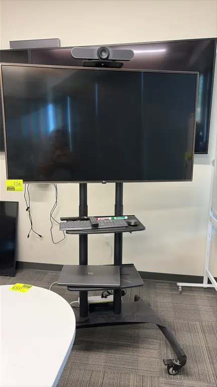 Mobile video conference workstation package. Includes 55" LG flat-screen TV, Logitech conference camera, Dell laptop, wireless keyboard, mouse, and re