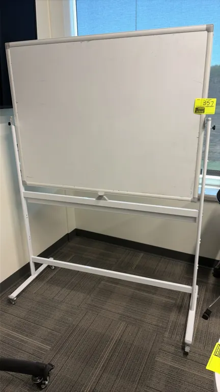 Double-sided portable whiteboard. Features reversible writing surface, marker tray, and aluminum frame. Dimensions: 4' x 3'. Mounted on a white metal