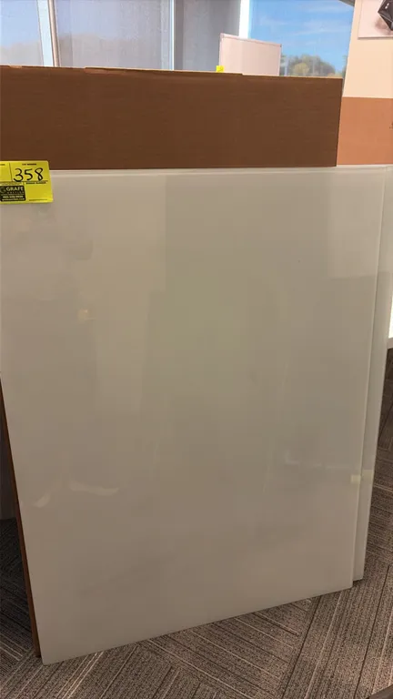 Tempered glass dry erase board. Features a frameless white glass surface with polished edges. 48" x 35 1/2".