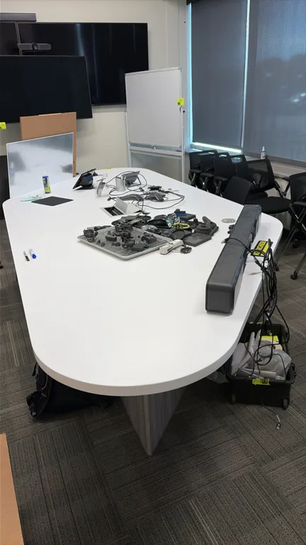 Conference table package. Includes 12' x 5' laminate conference table with integrated pop-up power and media ports, (10) mobile nesting office chairs