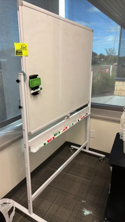 Double-sided portable dry erase board. Features a reversible pivoting whiteboard, aluminum trim, full-length marker tray, and locking adjustment knobs