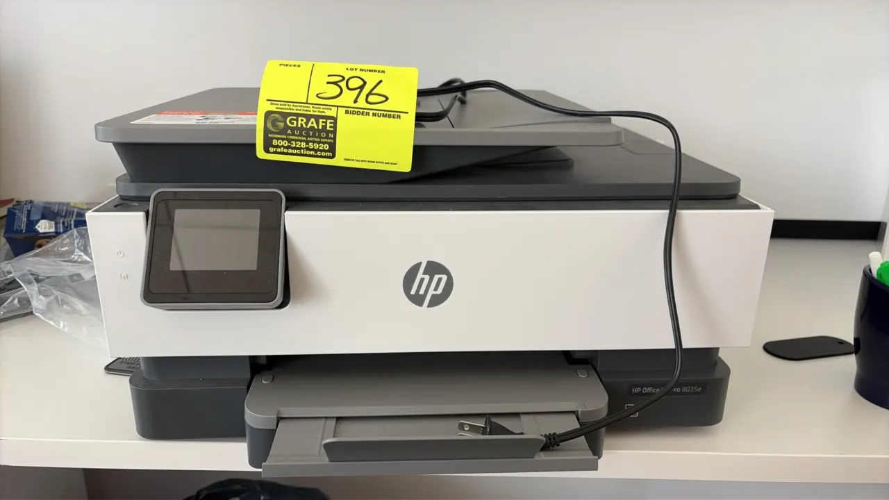 HP OfficeJet Pro 8035e all-in-one printer. Features automatic document feeder, touchscreen display, and pull-out paper tray. Includes power cord.