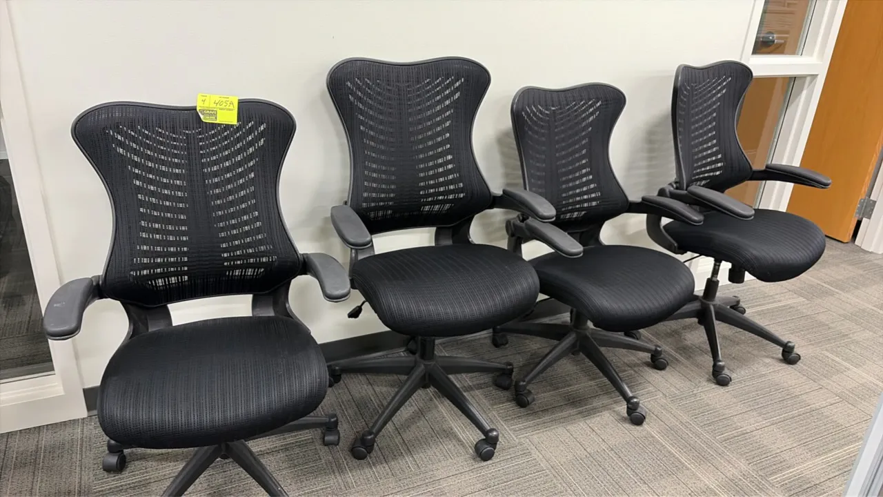 Office chairs. Features black mesh contoured backs, fabric upholstered cushioned seats, and integrated armrests. Equipped with pneumatic height adjust