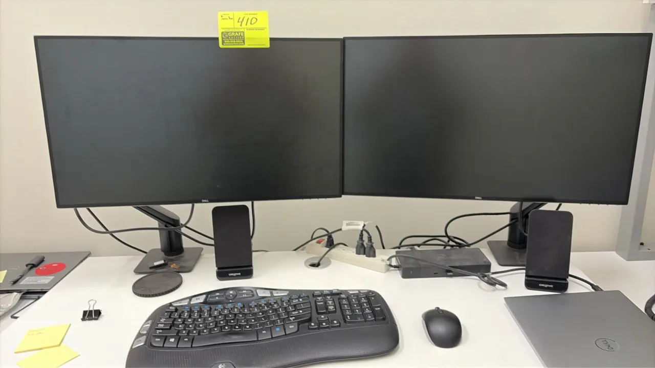 Computer peripherals lot. Includes (2) Dell 24" monitors on mounting stands, pair of Creative desktop speakers, ergonomic keyboard, and mouse. Note: D