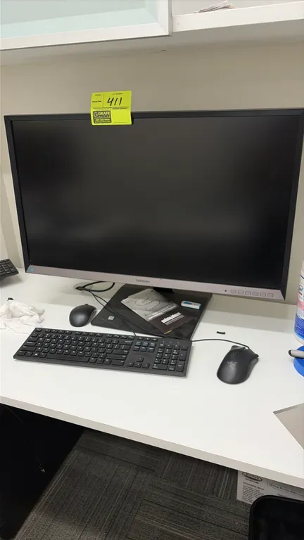 Samsung 32" computer monitor. Includes keyboard and mouse. Mounted on desktop stand. Note: Hard drive not included. Desk and background items not incl