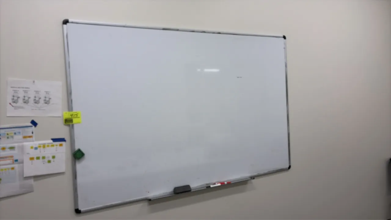 Dry erase whiteboard. Features an aluminum frame and an integrated marker tray. 6' x 4'. Wall-mounted.