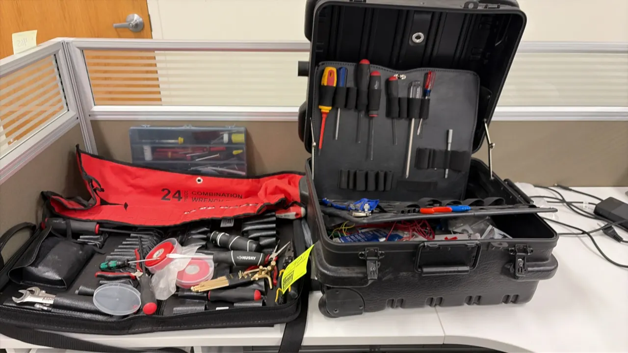 Assorted hand tools and technician carrying cases. Includes hard-sided wheeled tool case with tool pallet organizer inserts, zippered tool case, roll-