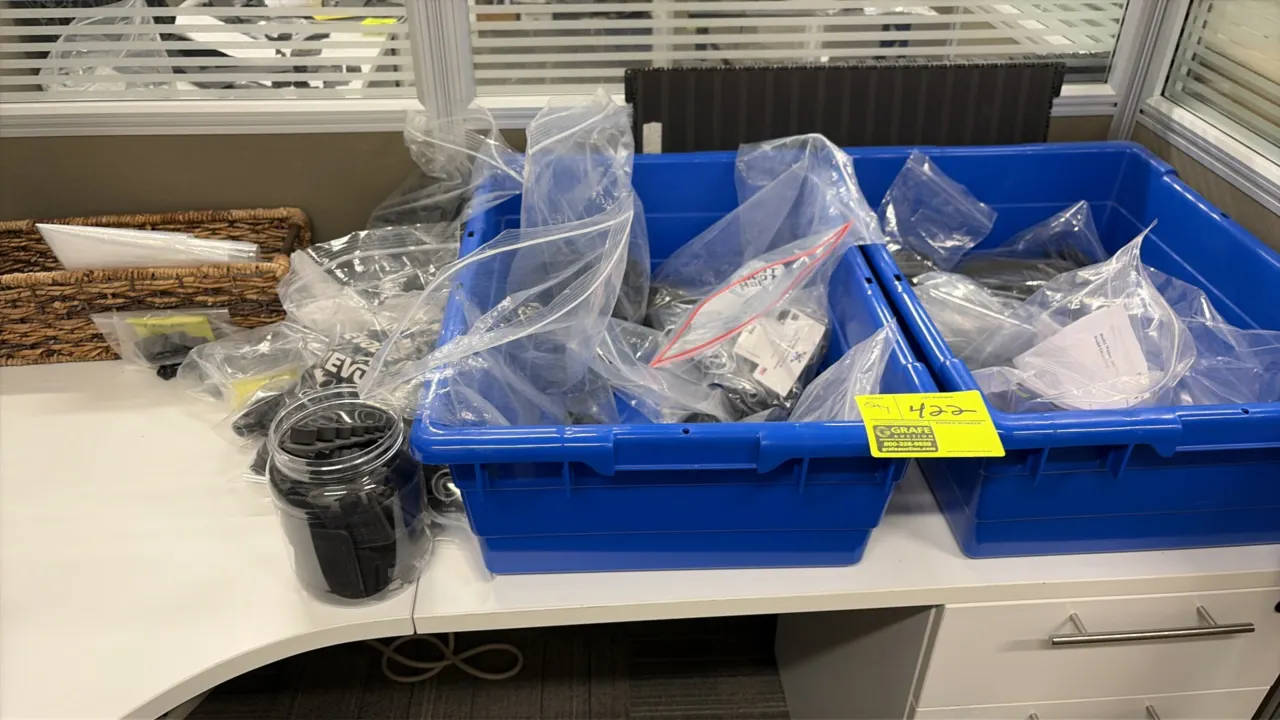 Assorted parts and hardware lot. Includes Evolve office furniture components, brackets, fasteners, and miscellaneous accessories contained in plastic