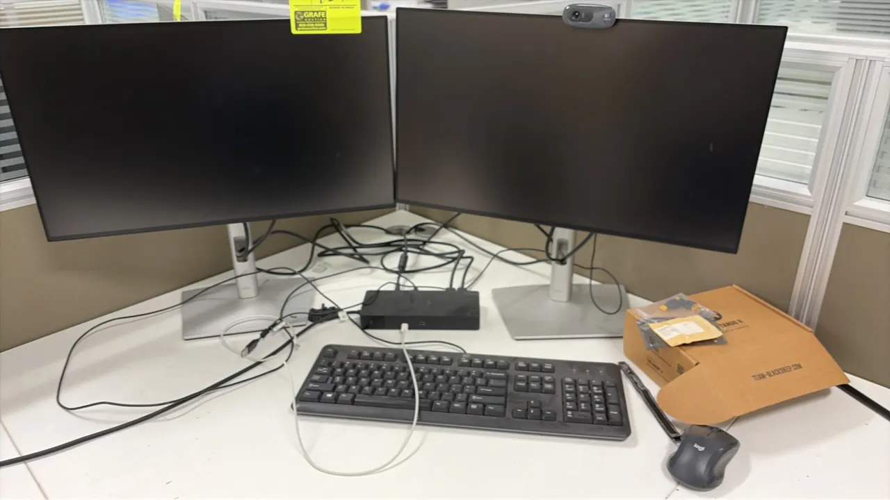 Dell 24" monitors. Features slim bezel screens. Mounted on adjustable desktop stands. Desk and surrounding accessories not included.