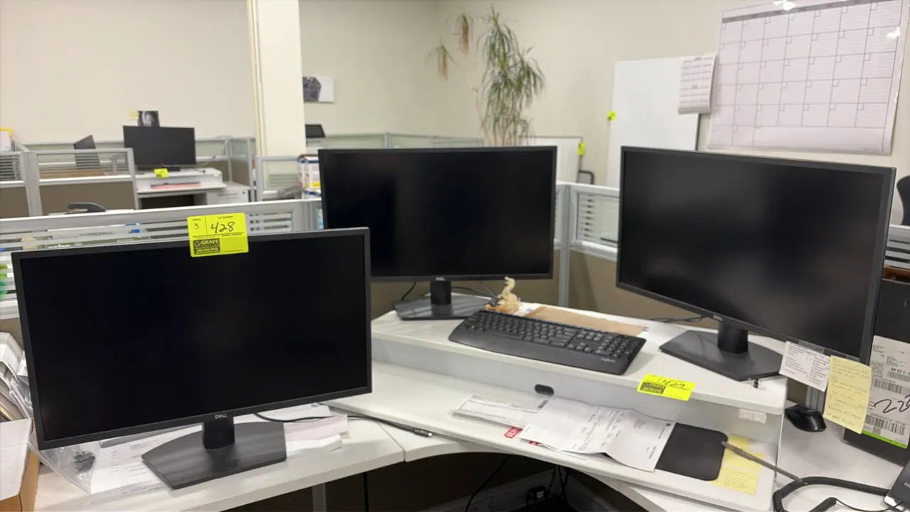 Dell 24" computer monitors with Logitech keyboard. Features widescreen displays mounted on desktop stands. Includes (1) black Logitech keyboard. Desk