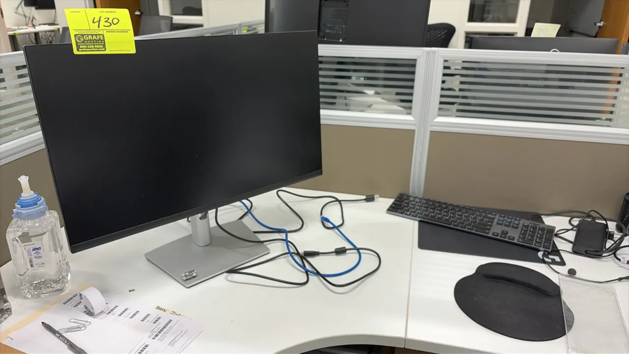 Dell 24" monitor. Includes keyboard, monitor stand, and assorted cables. Desk and background items not included.