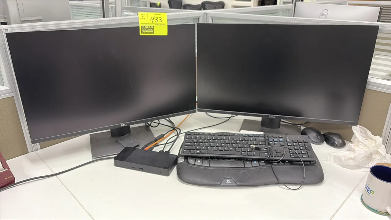 Dell computer workstation lot. Includes (2) 24" Dell monitors on adjustable stands, Dell docking station, (2) keyboards including a Logitech ergonomic