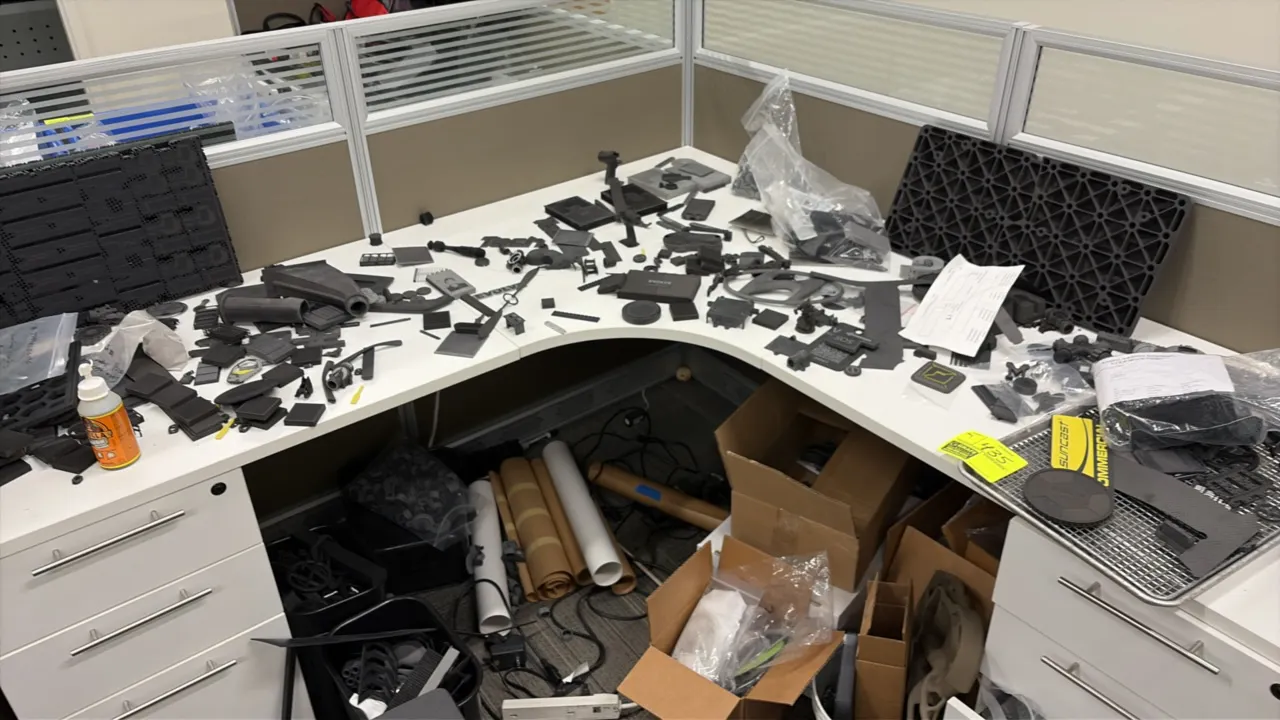 Assorted parts and components. Includes a variety of 3D-printed and molded plastic components, prototype parts, hardware, and miscellaneous pieces loc