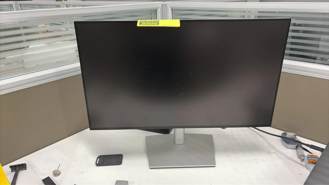 Dell computer monitor. Features a slim bezel display. 24". Mounted on an adjustable stand with a silver-tone base.