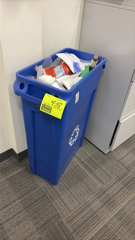 Rubbermaid Commercial Products Slim Jim recycling container. Features blue plastic construction with integrated handles, bag cinches, and universal re